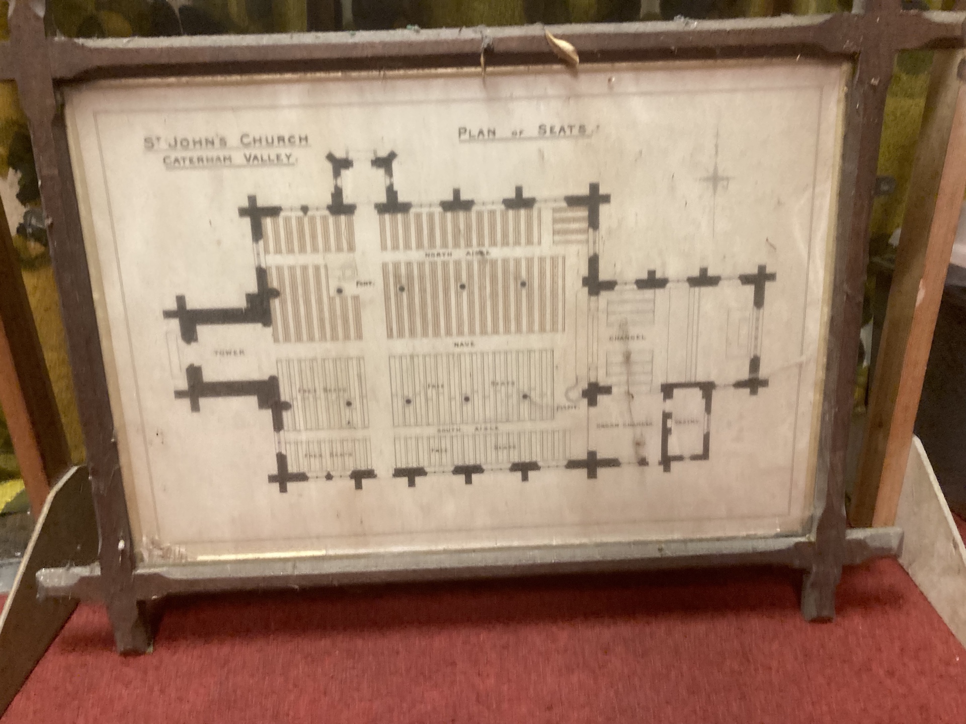 A framed seating plan for St John's, probably from before World War I.