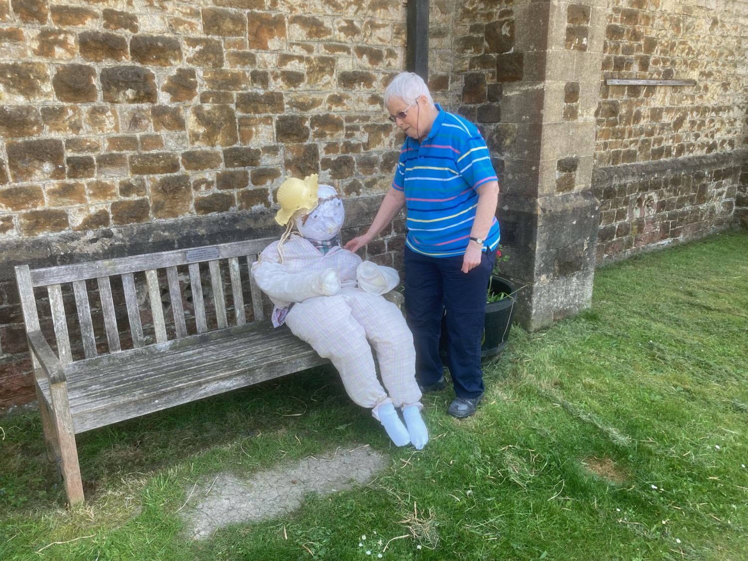 Scarecrow chats with churchwarden.